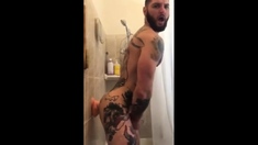 Tatted Hunk Fucks Dildo in Shower Until He Cums